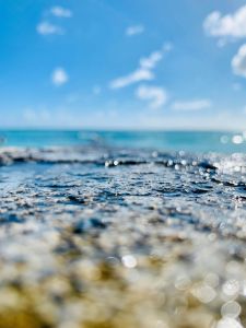Peaceful beach scene in Honolulu, Hawaii, capturing sparkling seawater and sky.