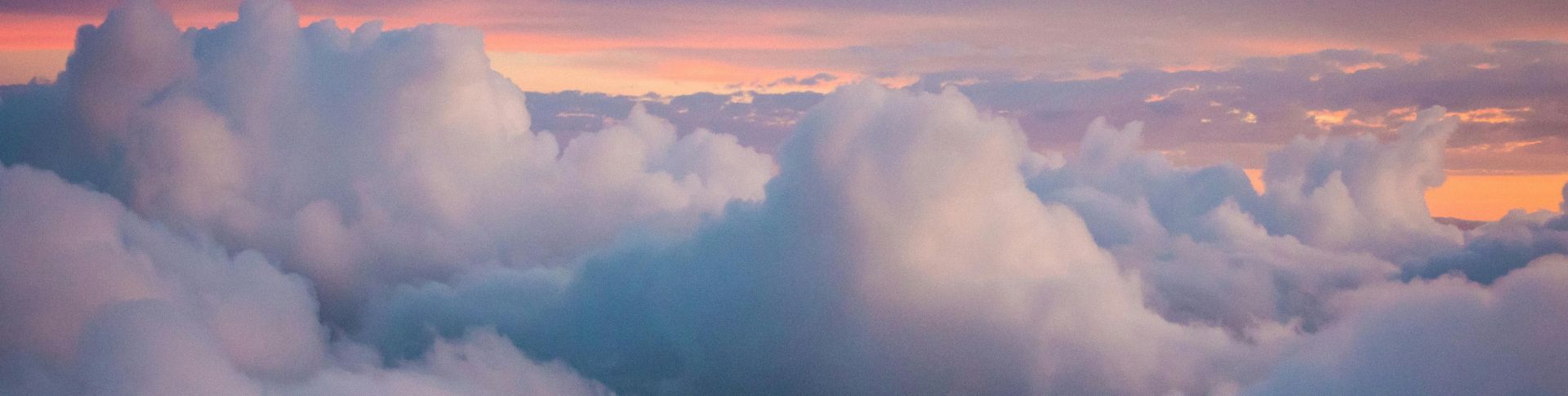 Beautiful golden sunrise over tranquil waters and distant mountains in Corfu, Greece.